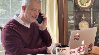 Image of Doug on the phone coaching a photographer.