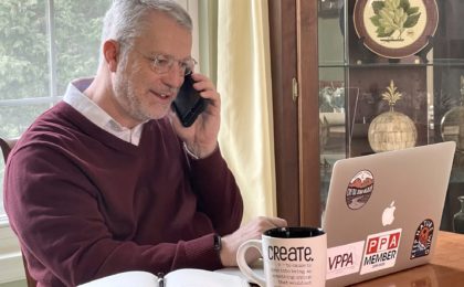 Image of Doug on the phone coaching a photographer.