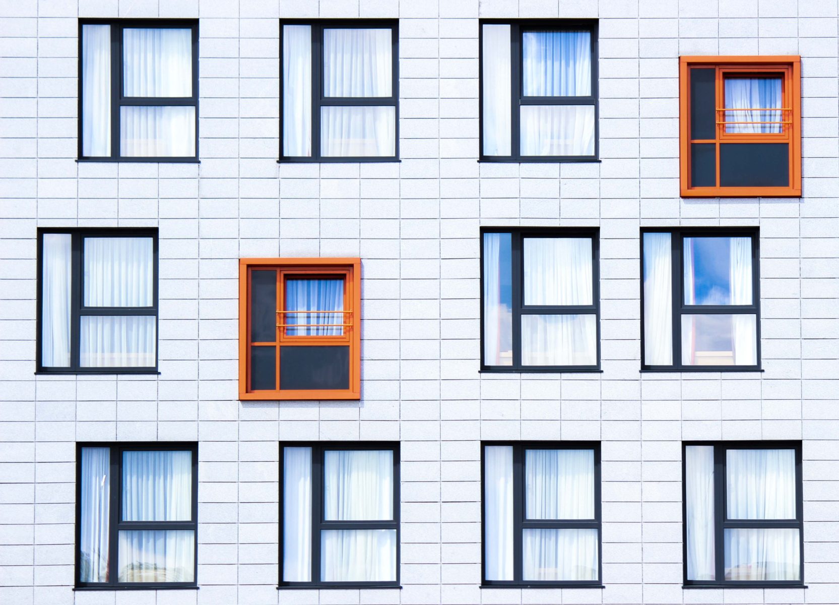 Photo of different windows with two standing out in color.