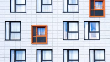 Photo of different windows with two standing out in color.