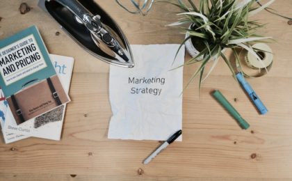 photo of desktop with Marketing Strategy paper on it.