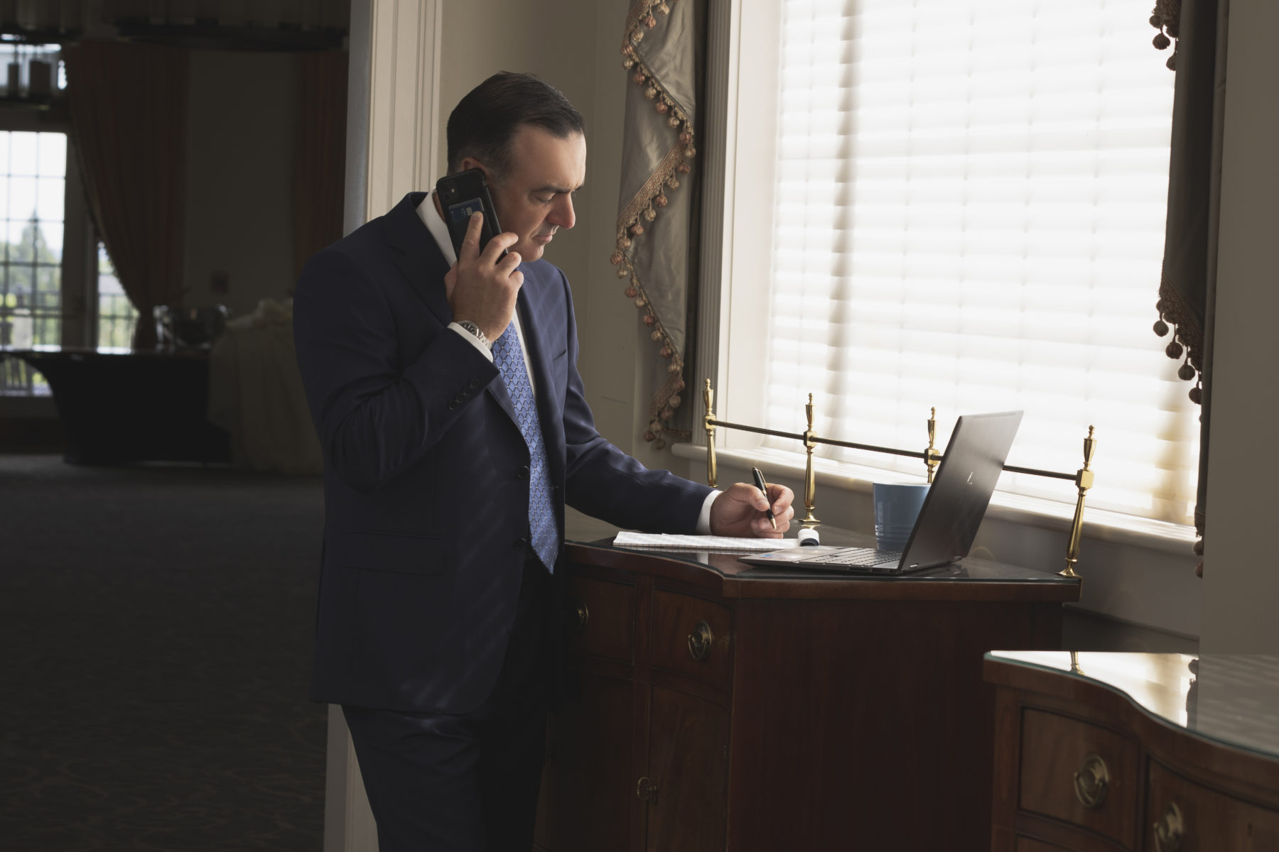 C.Williams 2-2188-73 Branding Photography photograph of person on the phone looking down on their laptop