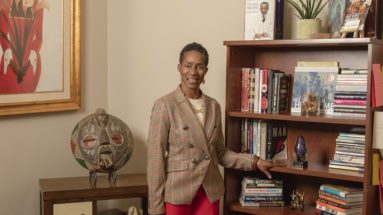Branding Client standing in her library.