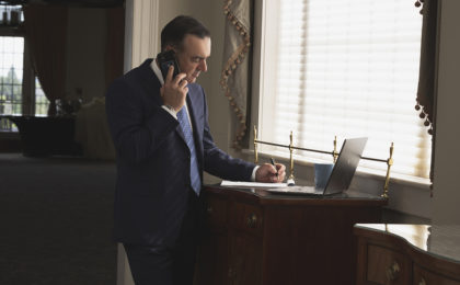 Branding photography image of a man taking notes while on the phone. Branding photography photographs makes it easier to attract your ideal client.
