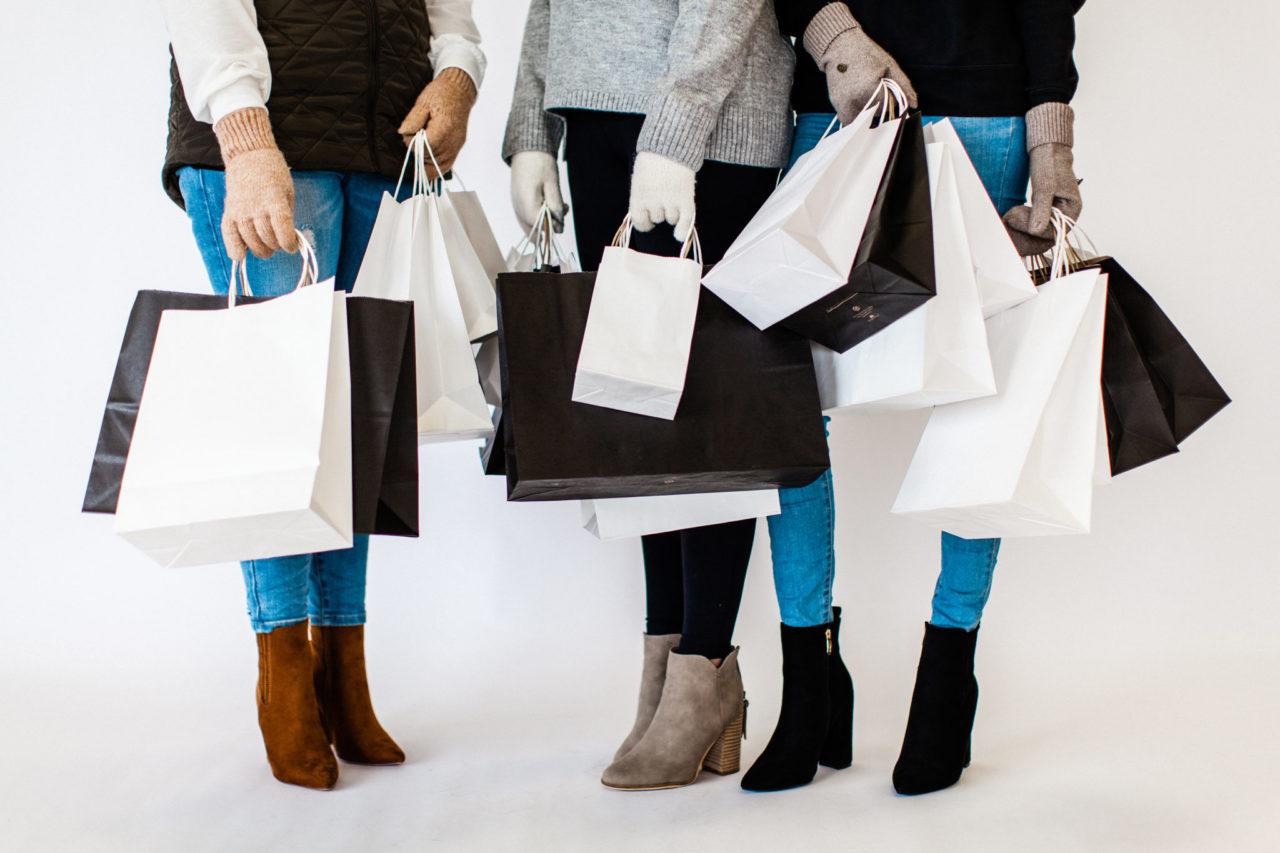 Want to know how to get more clients? Those who appreciate your work, advocate for you, and spend significant money with you? I think this article will help you. The photo is of three women talking while holding multiple shopping bags.