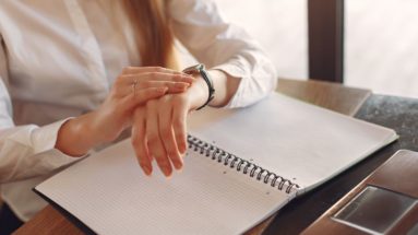 Maximize Your Productivity and Profitability with Effective Time Management Strategies—photograph of a female business person looking at her watch and a daily planner.