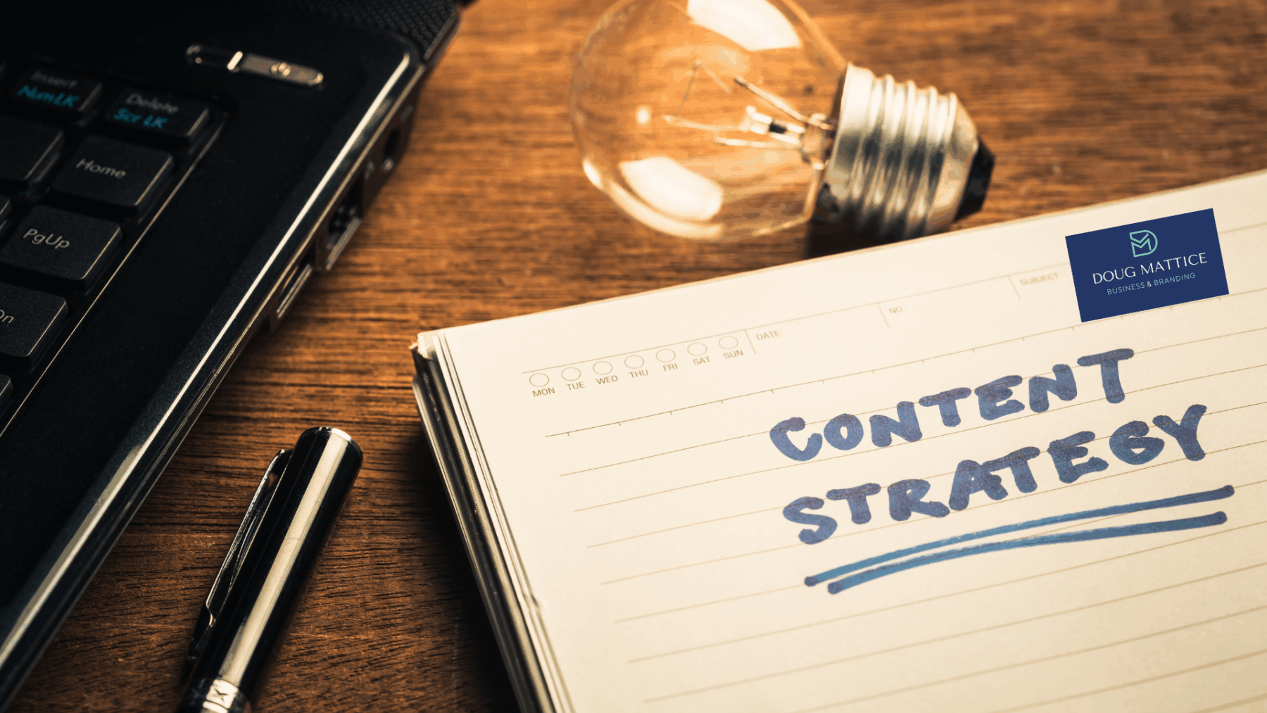 The notebook with the words Content Strategy is written in blue ink. The notebook is next to a light bulb and a laptop computer. If you are having challenges with your content marketing, you need to rethink your strategy.